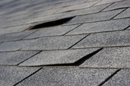roofing trouble - damage to shingles that needs repair and maintenance 